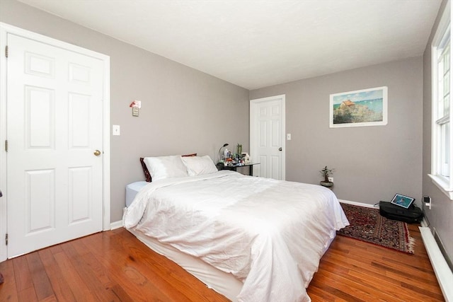 60 Spencer St Unit 60, Millis, MA 02054 - bedroom featuring wood finished floors, baseboards, and a baseboard radiator