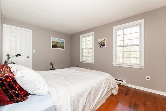 60 Spencer St Unit 60, Millis, MA 02054 - bedroom featuring a baseboard heating unit, wood finished floors, and baseboards
