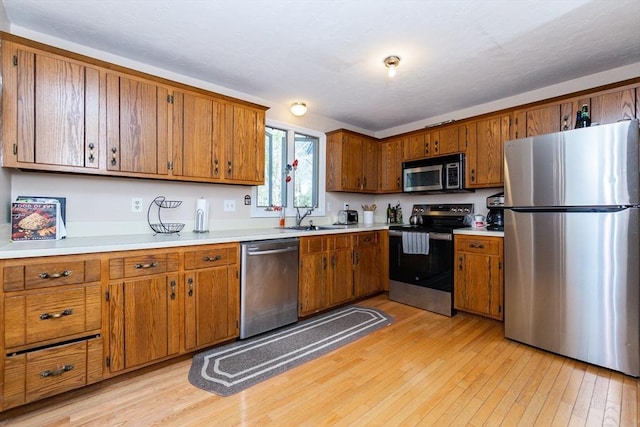 60 Spencer St Unit 60, Millis, MA 02054 - kitchen featuring stainless steel appliances, brown cabinets, and a sink