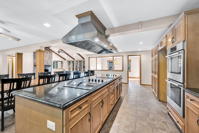 kitchen with light tile floors, stainless steel double oven, ceiling fan, and island exhaust hood