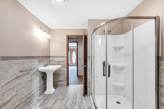 bathroom featuring walk in shower, tile walls, and tile floors