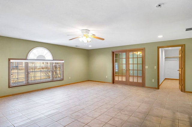 unfurnished room featuring ceiling fan, light tile floors, and french doors