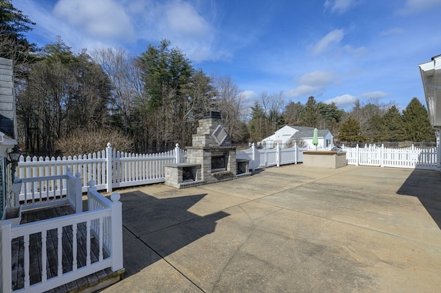 view of patio featuring an outdoor stone fireplace