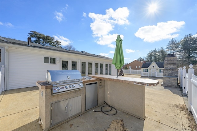 view of patio featuring grilling area and exterior kitchen