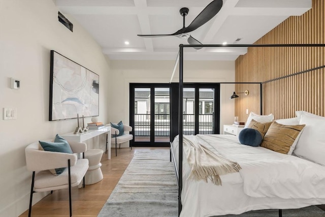 20 Clinton St Unit 22, Newton, MA 02458 - bedroom featuring coffered ceiling, access to exterior, wood finished floors, and beam ceiling