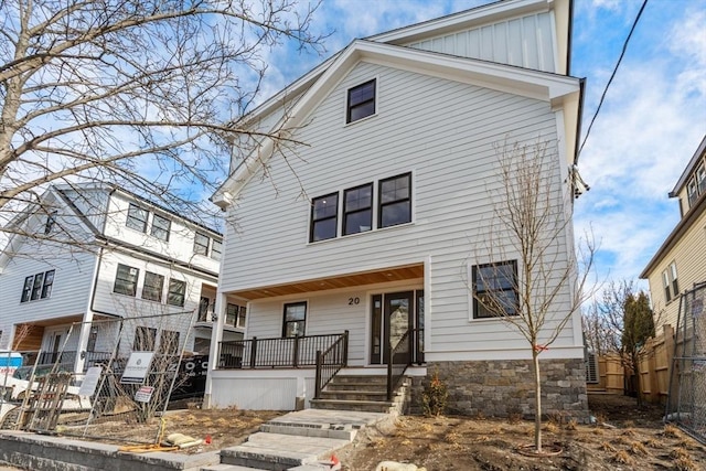 20 Clinton St Unit 22, Newton, MA 02458 - view of front facade with board and batten siding and a porch