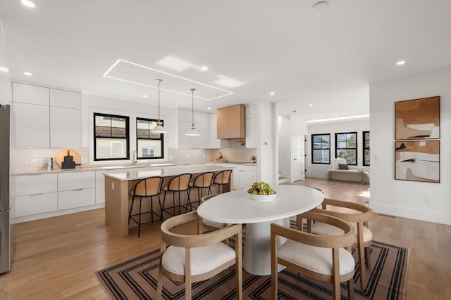 20 Clinton St Unit 22, Newton, MA 02458 - dining space featuring light wood-style flooring and recessed lighting