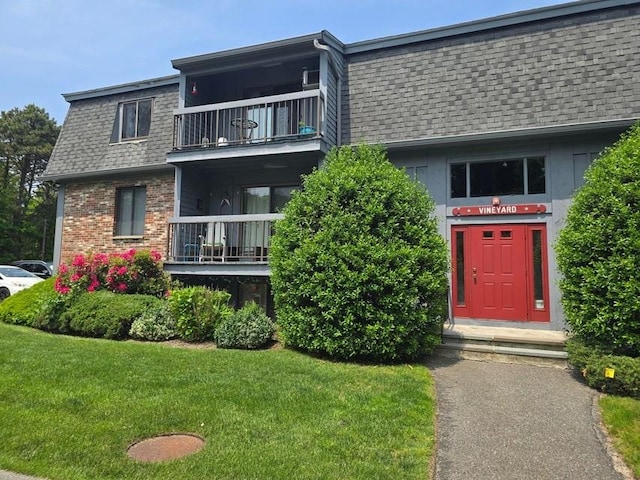 432 Old Chatham Rd Unit 504, Dennis, MA 02660 - view of front of house with a balcony, roof with shingles, a front lawn, and mansard roof