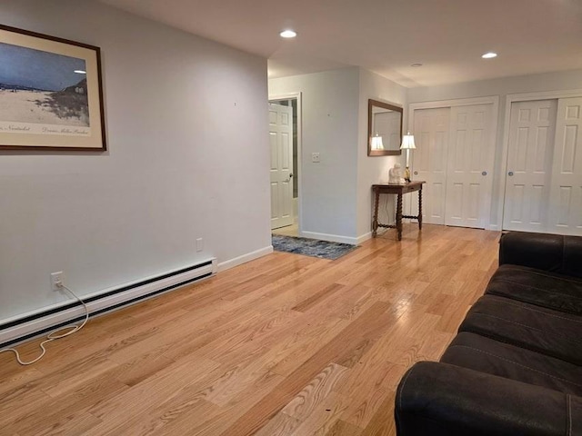 432 Old Chatham Rd Unit 504, Dennis, MA 02660 - unfurnished living room featuring a baseboard heating unit, light wood-style floors, and recessed lighting