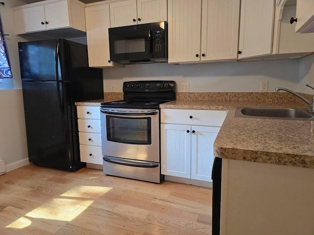 432 Old Chatham Rd Unit 504, Dennis, MA 02660 - kitchen with black appliances, light wood-style floors, white cabinetry, and light countertops