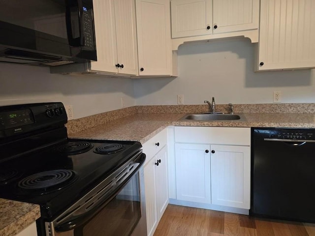432 Old Chatham Rd Unit 504, Dennis, MA 02660 - kitchen featuring black appliances, light wood finished floors, white cabinetry, and light countertops