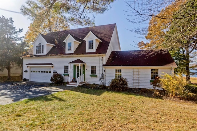 cape cod house with a front yard and a garage