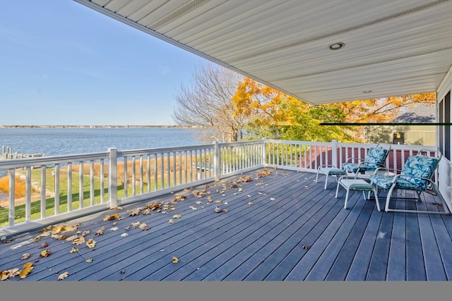 wooden terrace featuring a water view