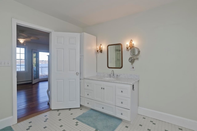 bathroom with vanity, hardwood / wood-style flooring, ceiling fan, and a baseboard radiator