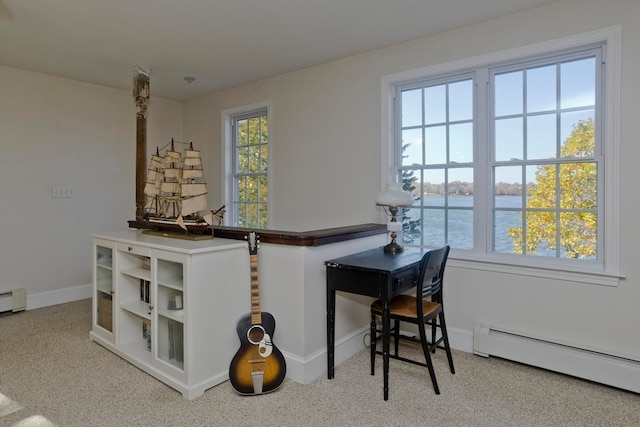 carpeted office with a baseboard heating unit and a water view