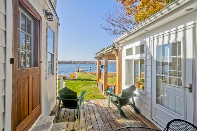 wooden terrace featuring a water view