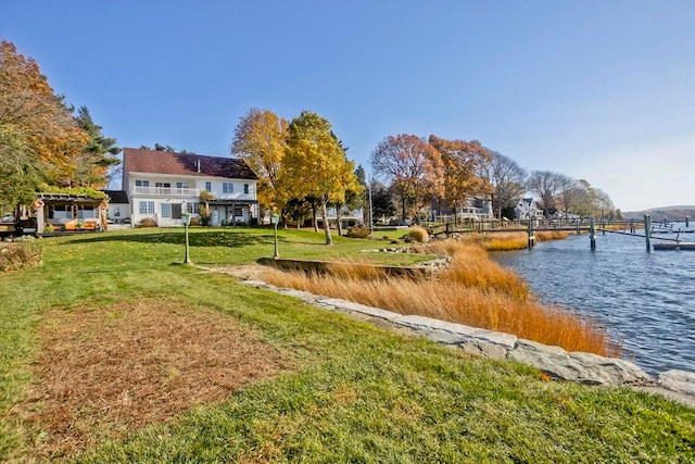 view of home's community featuring a water view and a yard