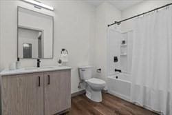 full bathroom with vanity, toilet, shower / tub combo, and hardwood / wood-style floors