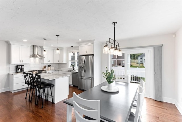 dining area with recessed lighting, dark wood-style flooring, and baseboards