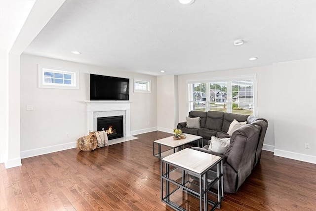 living area featuring dark wood-style floors, recessed lighting, a fireplace, and baseboards