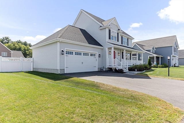 traditional-style house with a garage, aphalt driveway, fence, a porch, and a front yard