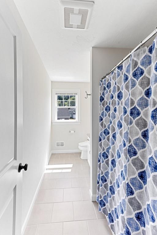 full bath featuring toilet, tile patterned flooring, visible vents, and vanity