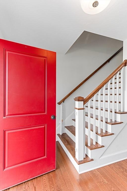 stairs featuring wood finished floors