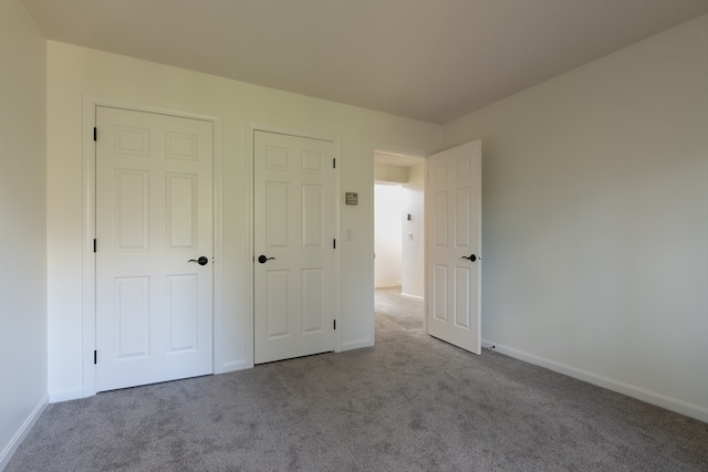 unfurnished bedroom featuring light colored carpet