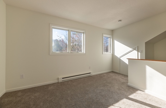 empty room featuring carpet floors and a baseboard radiator