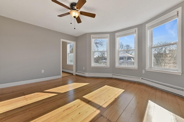 unfurnished room with ceiling fan, a healthy amount of sunlight, and light hardwood / wood-style floors