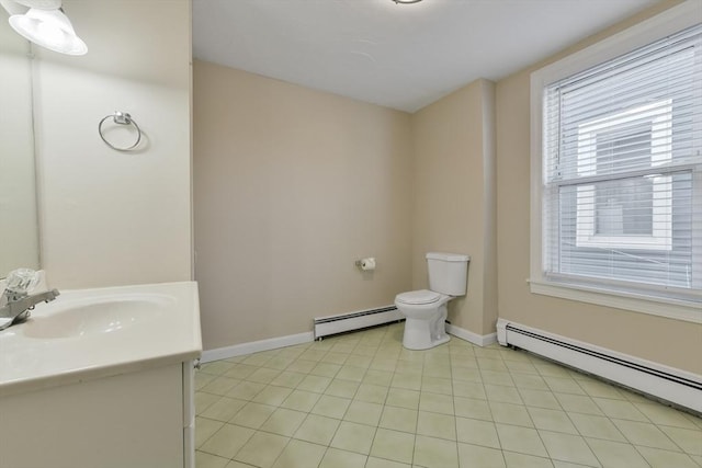 bathroom with tile patterned floors, vanity, toilet, and a baseboard heating unit