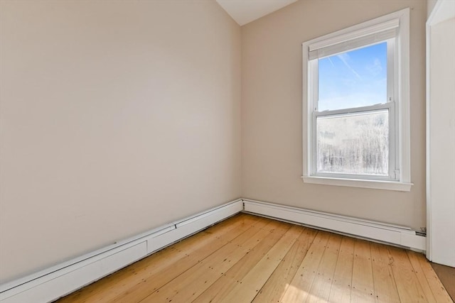 spare room featuring hardwood / wood-style floors and baseboard heating