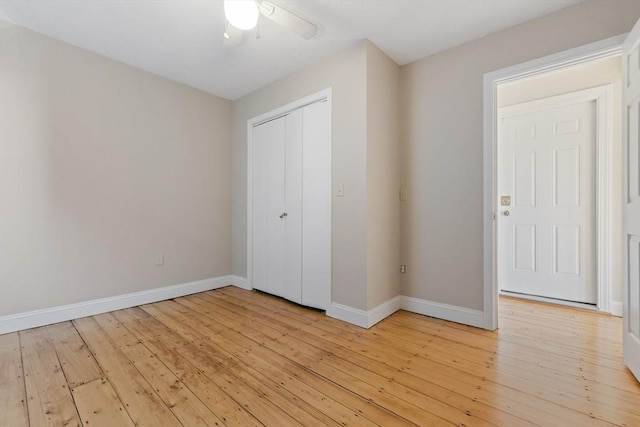 unfurnished bedroom featuring ceiling fan, light hardwood / wood-style floors, and a closet