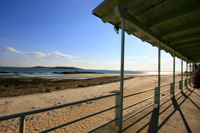 exterior space featuring a view of the beach and a water view