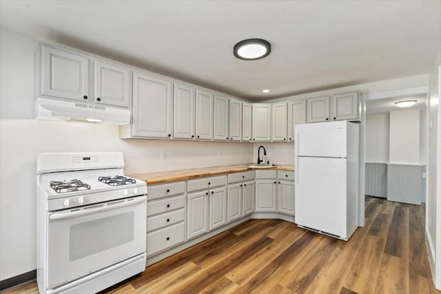 16 Rantoul St, Beverly, MA 01915 - kitchen featuring white appliances, under cabinet range hood, wooden counters, wood finished floors, and recessed lighting