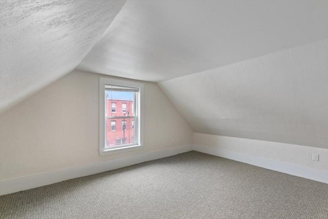 16 Rantoul St, Beverly, MA 01915 - additional living space with lofted ceiling, carpet floors, and a textured ceiling
