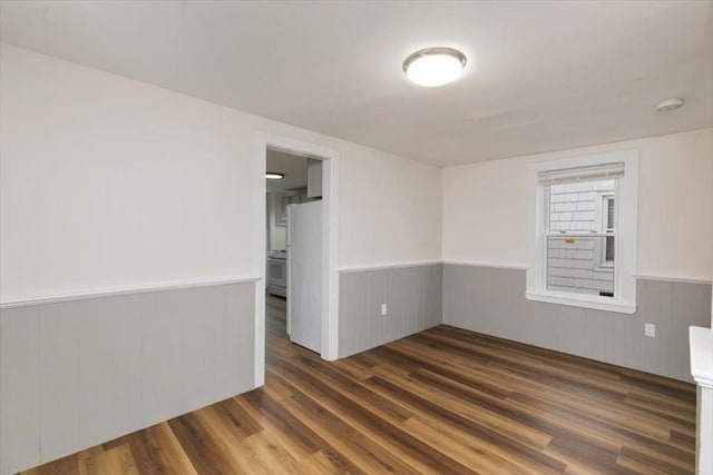 16 Rantoul St, Beverly, MA 01915 - unfurnished room with a wainscoted wall, wood finished floors, wooden walls, and a smoke detector