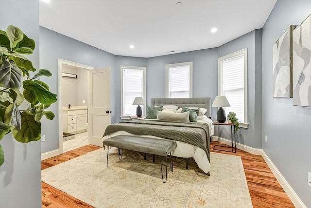 64 Clarkwood Unit 2, Boston, MA 02126 - bedroom featuring multiple windows, wood finished floors, ensuite bath, recessed lighting, and a wall mounted AC