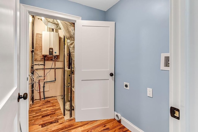 64 Clarkwood Unit 2, Boston, MA 02126 - washroom featuring water heater, hookup for an electric dryer, light wood finished floors, and washer hookup