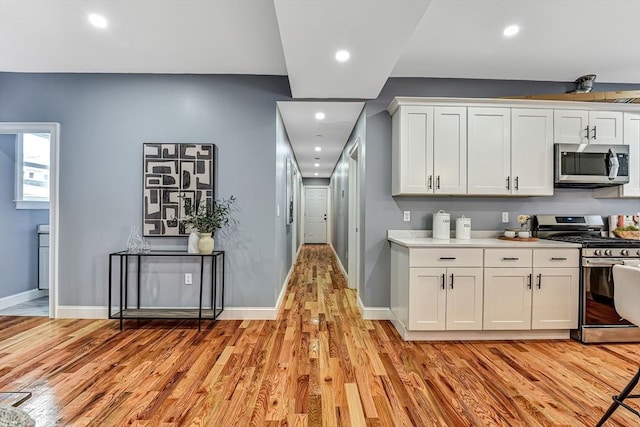 64 Clarkwood Unit 2, Boston, MA 02126 - kitchen featuring appliances with stainless steel finishes, light wood finished floors, white cabinets, recessed lighting, and light countertops