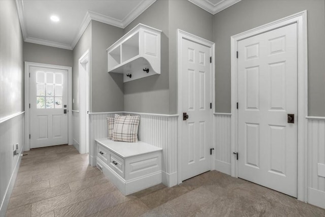 mudroom with a wainscoted wall and ornamental molding