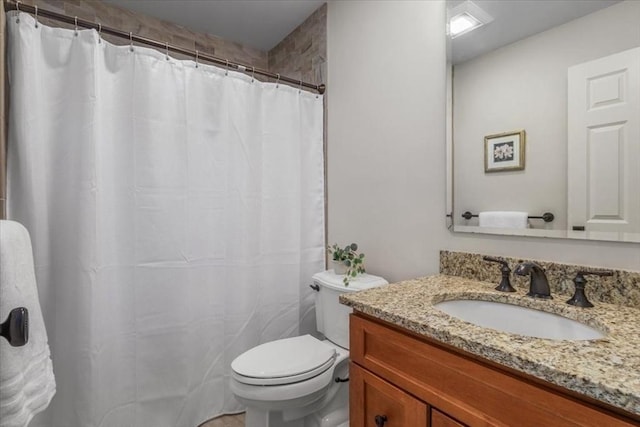 bathroom with toilet, curtained shower, and vanity