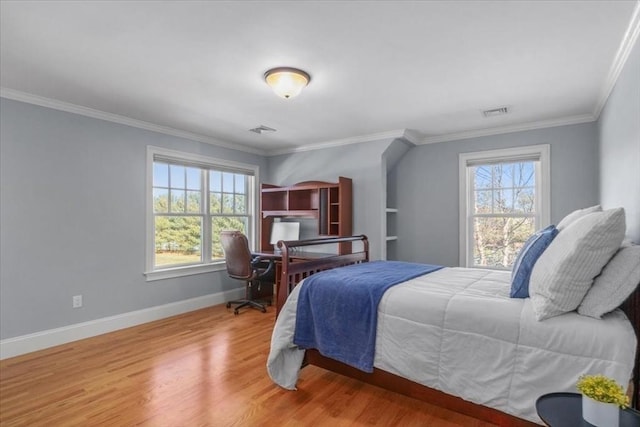 bedroom featuring crown molding, multiple windows, wood finished floors, and baseboards