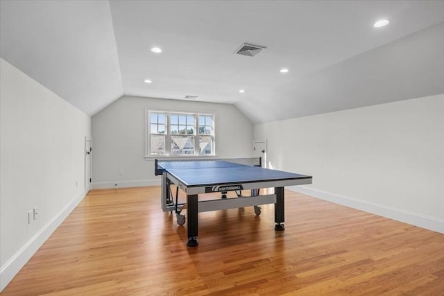 playroom with lofted ceiling, light wood-style floors, baseboards, and visible vents