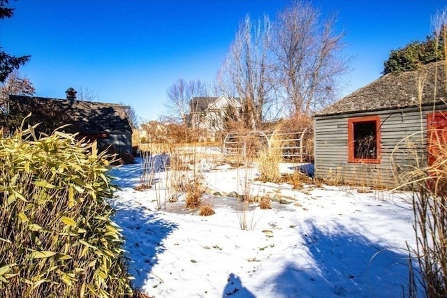 snowy yard featuring fence