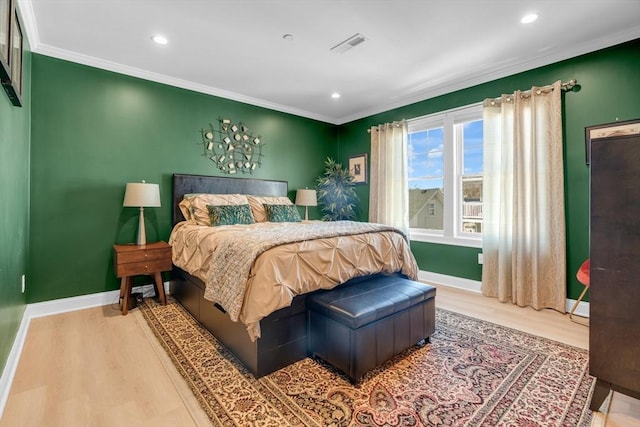 bedroom featuring wood finished floors, visible vents, and baseboards