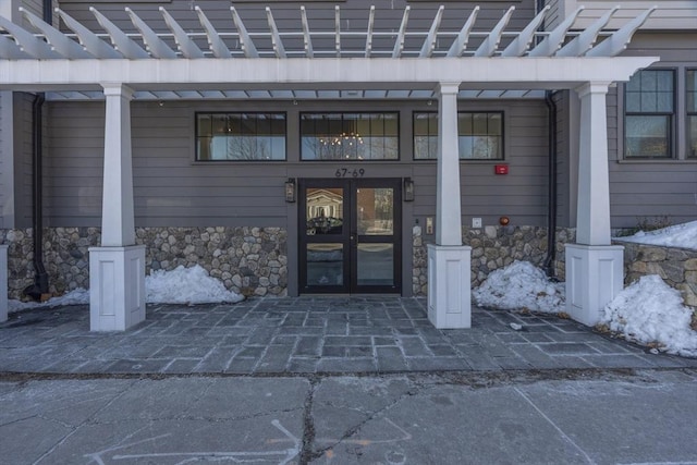 property entrance with french doors and stone siding