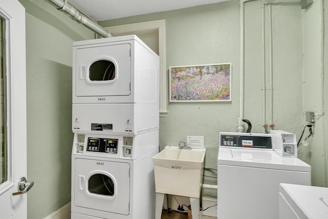 washroom featuring sink, stacked washing maching and dryer, and independent washer and dryer