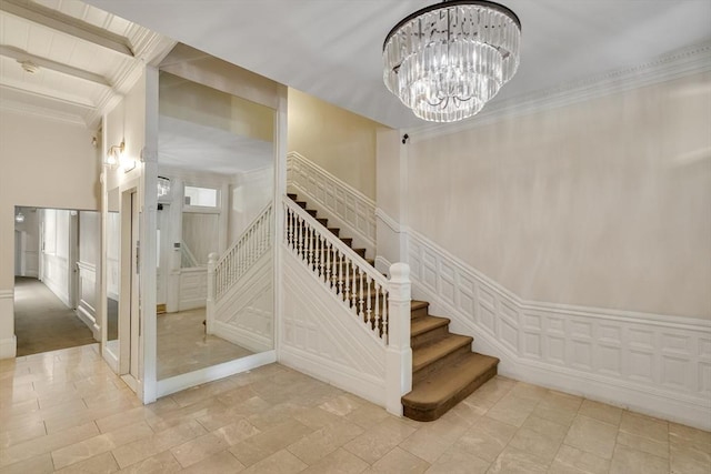 stairway featuring beamed ceiling, a notable chandelier, and a high ceiling