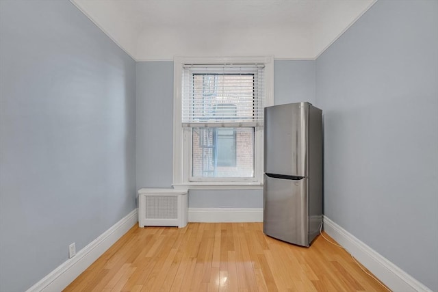 interior space featuring radiator and light hardwood / wood-style floors